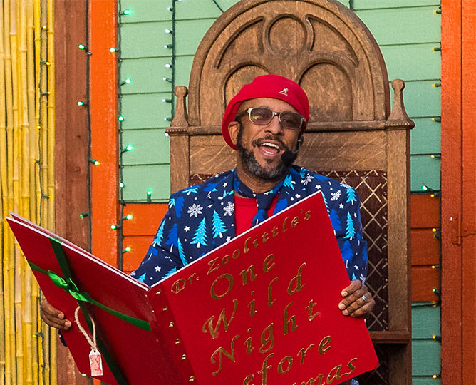 Dr. Zoolittle reading from an oversized bright red book